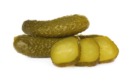 Tasty sliced and whole pickled cucumbers on white background