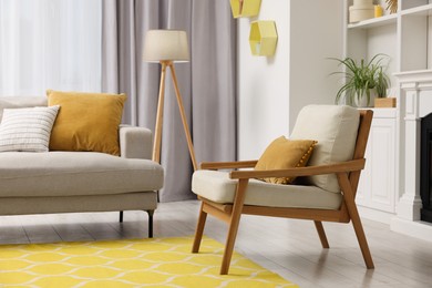 Photo of Spring atmosphere. Comfy sofa, lamp and armchair in room