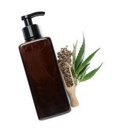 Bottle of hemp cosmetics with green leaves and seeds isolated on white, top view