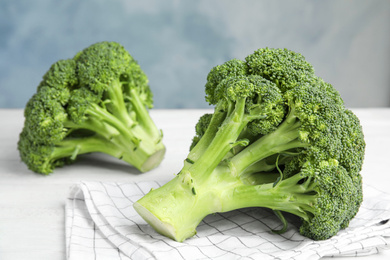 Fresh green broccoli on white wooden table, closeup