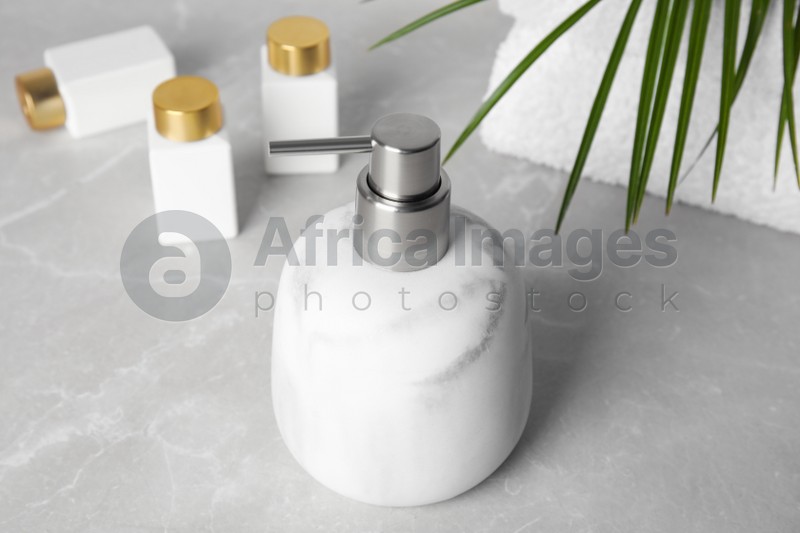 Modern marble soap dispenser on light table