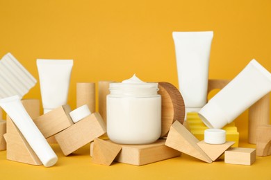 Composition with different cosmetic products on orange background