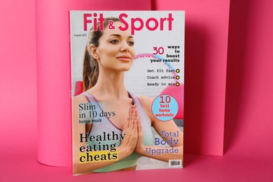 Modern printed sports magazine on pink background