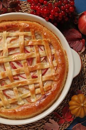 Delicious homemade apple pie and autumn decor on blue wooden table, flat lay. Thanksgiving Day celebration