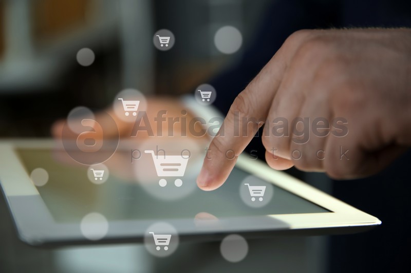 Delivery concept. Man using modern tablet for online shopping indoors, closeup. Market cart illustrations