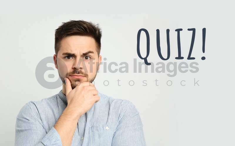 Thoughtful man and word QUIZ on white background 
