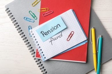 Flat lay composition with words PENSION FUND on white wooden background
