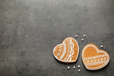 Tasty heart shaped gingerbread cookies on black table, flat lay. Space for text