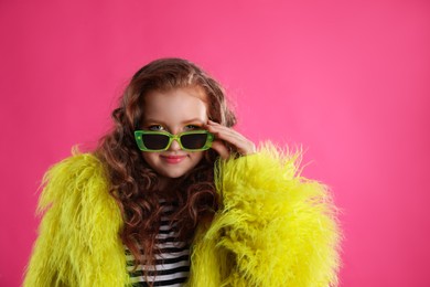 Cute indie girl with sunglasses on pink background, space for text