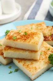 Photo of Delicious turnip cake with parsley on plate, closeup