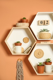 Shelves with decorative elements on color wall. Interior design