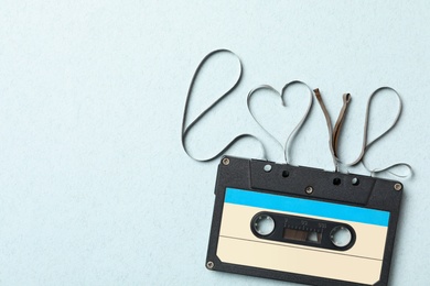 Top view of music cassette and word Love made with tape on turquoise background, space for text. Romantic songs