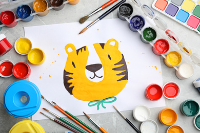 Flat lay composition with child's painting of tiger on marble table