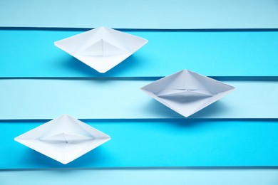 Competition concept. Paper boats on colorful background, flat lay