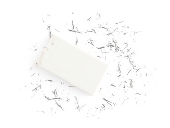 Eraser and grey crumbs on white background, top view