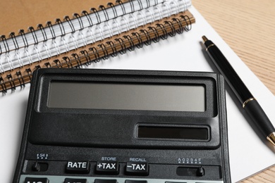 Calculator, pen and notebooks, closeup. Tax accounting