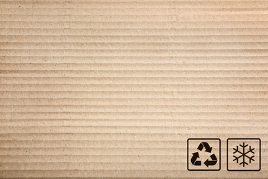 Cardboard box with packaging symbols as background, closeup