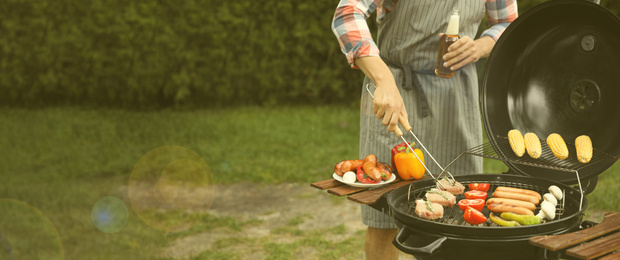 Man having picnic and cooking food on barbecue grill outdoors, closeup with space for text. Banner design