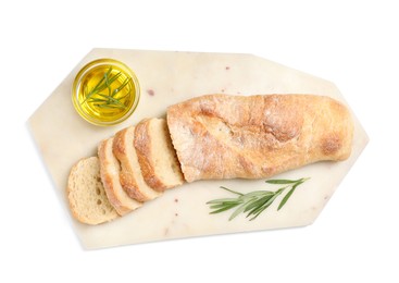 Cut delicious French baguette with rosemary and oil isolated on white, top view
