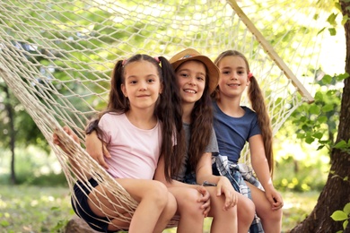 Little girls in hammock outdoors. Summer camp