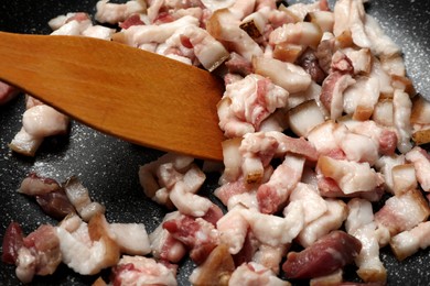 Frying cracklings in cookware, closeup. Pork lard