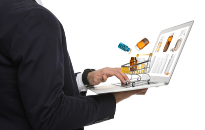 Image of Man with laptop ordering medications online on white background, closeup