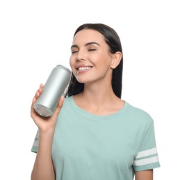 Beautiful happy woman drinking from beverage can on white background