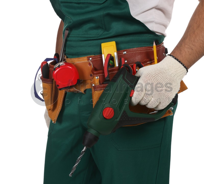 Worker in uniform with power drill on white background, closeup