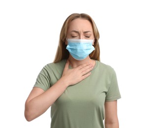 Young woman in medical mask suffering from pain during breathing on white background