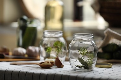 Photo of Empty glass jars and ingredients prepared for canning on table. Space for text
