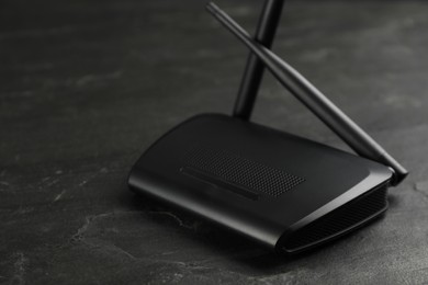 Modern wireless Wi-Fi router on black background