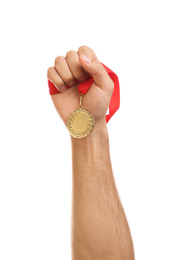 Man holding golden medal on white background, closeup. Space for design