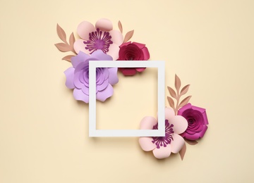 Different beautiful flowers made of paper and frame on beige background, flat lay. Space for text