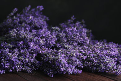 Beautiful fresh lavender flowers on wooden table, closeup