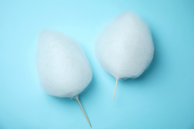 Photo of Flat lay composition with sweet cotton candies on light blue background