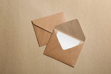 Brown paper envelopes on color background, flat lay
