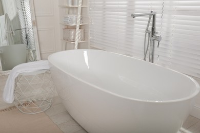 Minimal bathroom interior with modern white tub