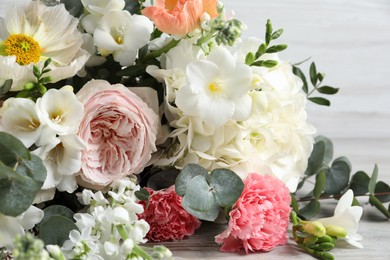Photo of Bouquet of beautiful flowers on wooden table, closeup