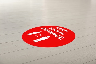 Sign KEEP SOCIAL DISTANCE on floor indoors. Coronavirus pandemic