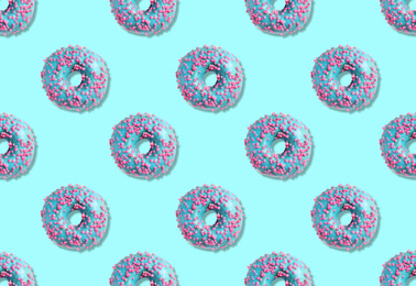 Image of Creative pattern design of glazed donuts on light blue background