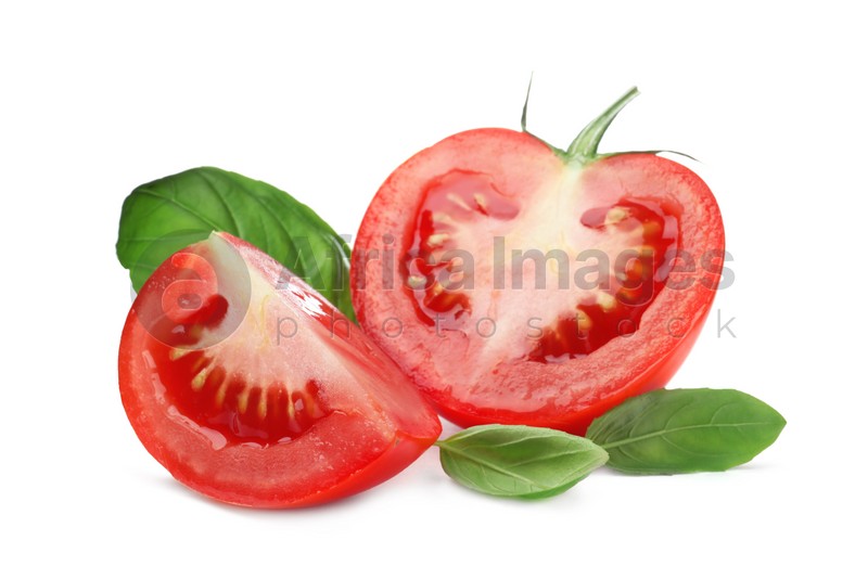 Photo of Fresh green basil leaves and cut tomato on white background