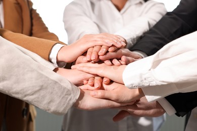 Group of people holding hands together, closeup. Unity concept