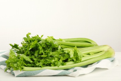 Photo of Fresh ripe green celery on white wooden table