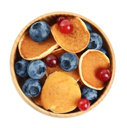 Delicious mini pancakes cereal with berries on white background, top view