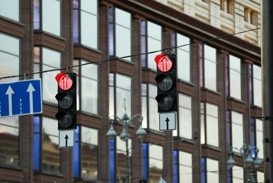 View of traffic lights and road signs in city