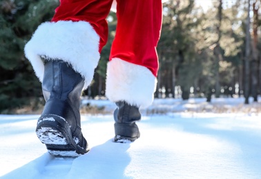 Authentic Santa Claus walking outdoors, focus on legs