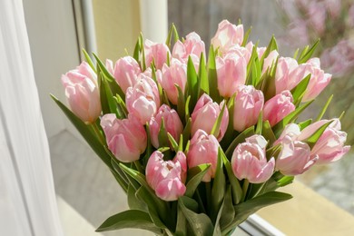 Photo of Spring is coming. Bouquet of beautiful tulip flowers in glass vase on windowsill indoors, closeup