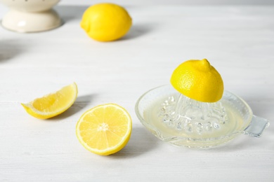 Slices of lemon and juicer on light table