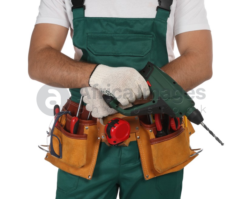 Worker in uniform with power drill on white background, closeup