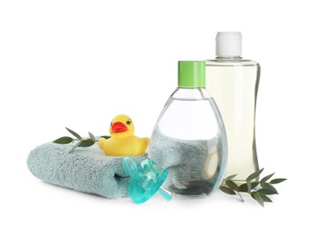 Bottles of baby oil, accessories and rubber duck on white background